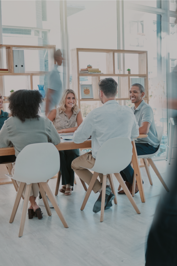De afbeelding toont een ontspannen vergadering in een lichte, moderne kantoorruimte.
